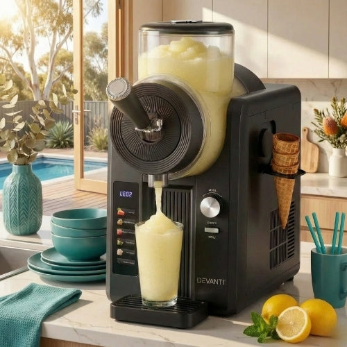 A black slushie machine from Rivercity Furniture Australia dispensing lemonade slush on a modern kitchen counter, styled with teal Rivercity Furniture accessories.